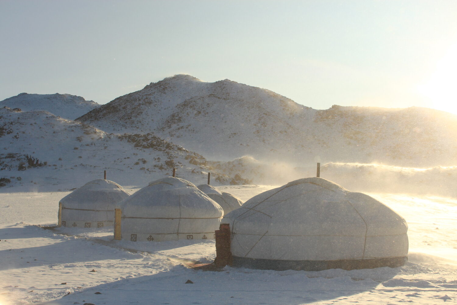 Experience the magic of winter in Mongolia's Altai Mountains with a stay in an authentic Mongolian ger, nestled amidst a serene snowy landscape.