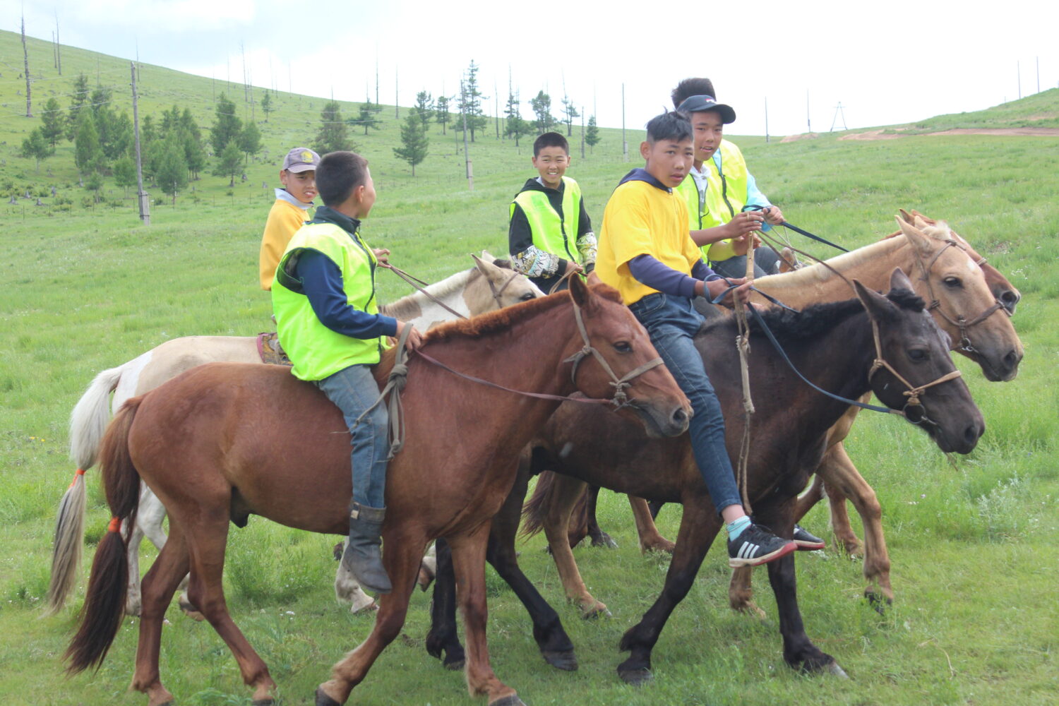 mongolian children horse riding in Naadam festival