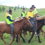 mongolian children horse riding in Naadam festival