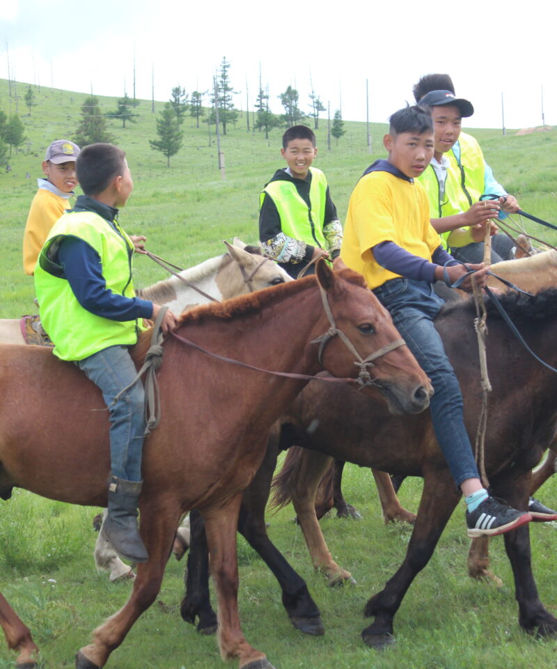 mongolian children horse riding in Naadam festival