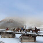 mongolioans riding horses in winter in khuvsgul